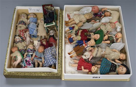 A collection of twenty six miniature dolls, a dolls pram and sheep